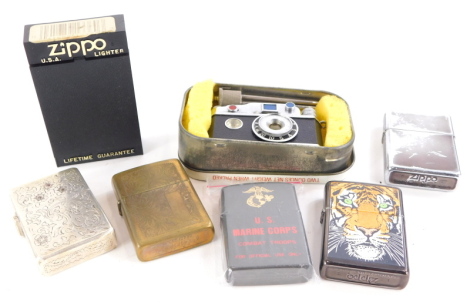 A quantity of novelty and other lighters, to include Zippo, US Marine Corp lighter, another silver plated inset with red and white stones, a novelty camera and tripod, lighter, etc.