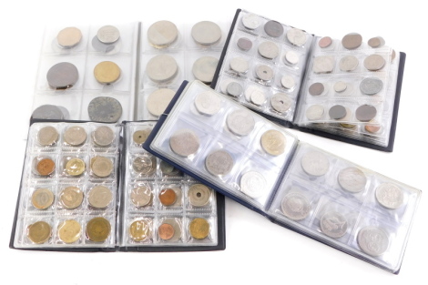 Four small albums of various world coins.