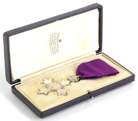 A silver early 20thC silver M.B.E, London 1917, issued in a Garrard and Co. fitted case, with purple ribbon, believed to be one of the first 600 issued.