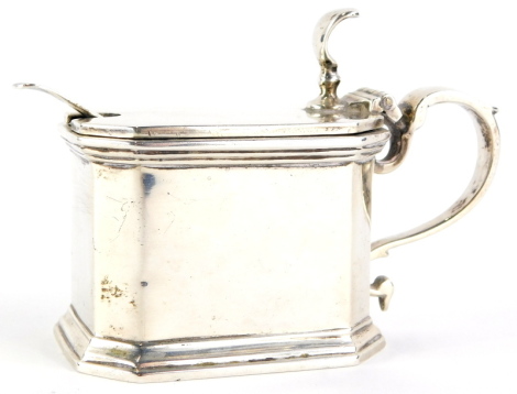 A George IV canted rectangular silver mustard pot, with shaped handle and blue glass liner and associated spoon, Birmingham 1922, 4oz.