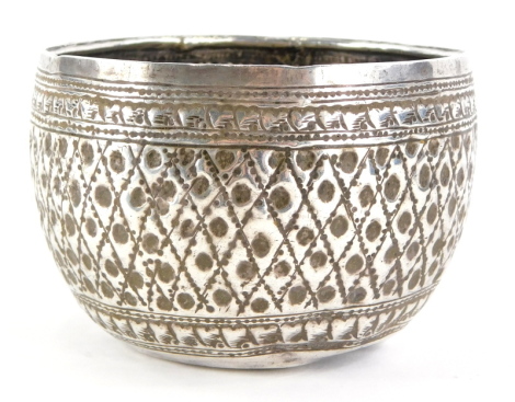 An Eastern metal bowl, with punched or embossed decoration, 3½oz.