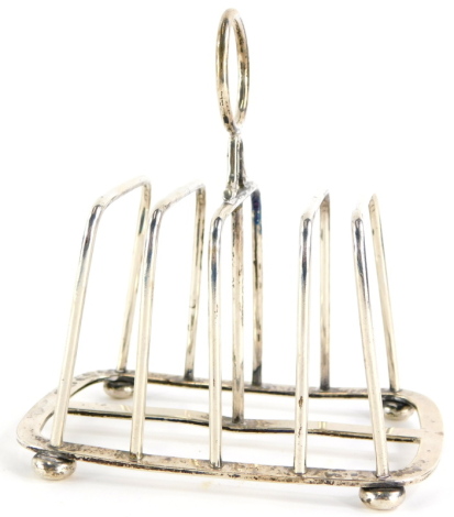 A late Victorian silver four division toast rack, on ball feet, (AF), London 1897, 4½oz.