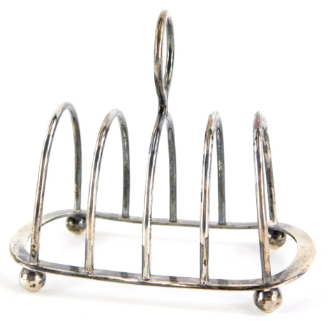 A small Victorian silver four division toast rack, with bun feet, London 1898, 2oz.