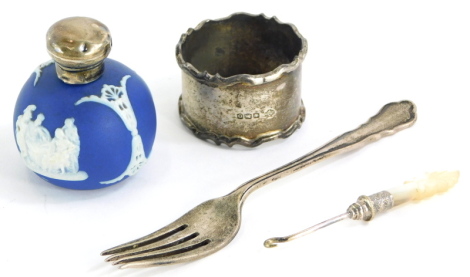 A Wedgwood type Jasperware scent bottle, with silver mounts, (AF), a small silver fork, a napkin ring, and a mother of pearl handle button hook. (4)