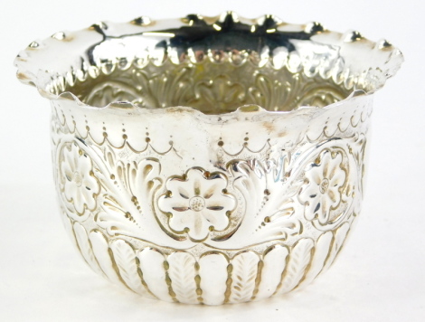 A Victorian sugar bowl, with a petalated border, and embossed with flowers, scrolls, etc., with two vacant circular cartouches, Sheffield 1888, 1¼oz, 9cm diameter.