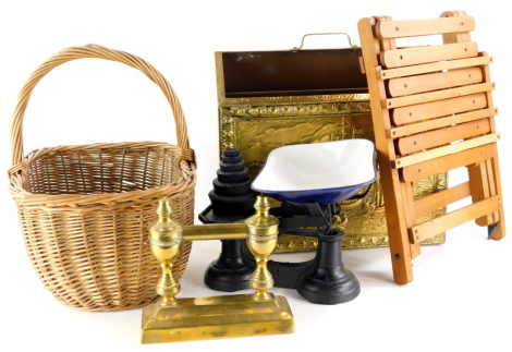 A set of scales and weights, an embossed brass magazine rack, a basket, a fire dog and a small folding table.