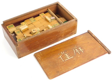 A Mahjong game, in hardwood box with sliding lid.