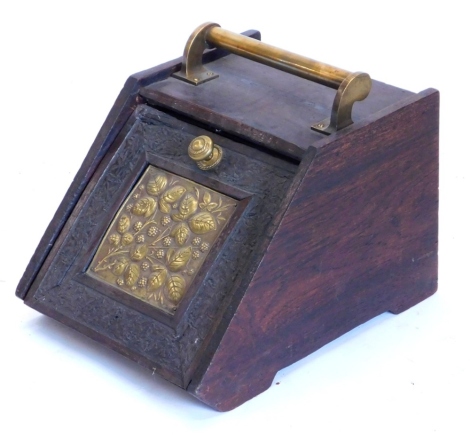 A late Victorian mahogany coal scuttle, with later brass handle, the door applied with an Aesthetic style panel of berries and leaves, 30cm wide.