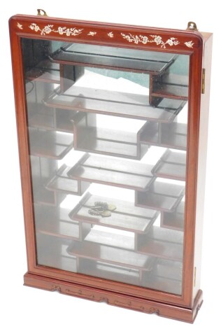 An oriental hardwood and mother of pearl inlaid display case, with various shelves, 84cm high, 51cm wide.