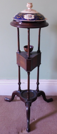 A 19thC mahogany wash stand, with circular moulded top in set with a Davenport style porcelain tureen and cover (AF), tri-form centre with two drawers, three uprights and tripod splay legs.