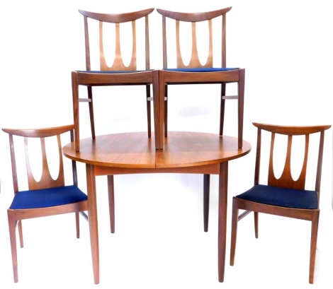 A 1960s/70s teak extending dining table, on turned tapering legs, and four contemporary chairs, each with a pierced back, a padded seat on square tapering legs, in the Scandinavian style, the table 110cm diameter. The upholstery in this lot does not compl