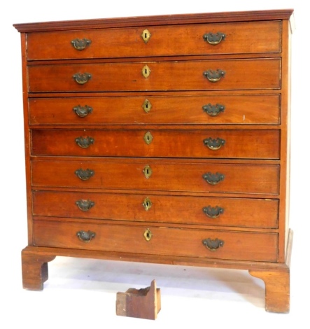 An early 19thC mahogany chest of drawers, the top with a crossbanded border and a moulded frieze, above an arrangement of seven long drawers, on bracket feet, 113cm high, 111cm wide, 57cm deep, (AF). Note: VAT is payable on the hammer price of this lot at