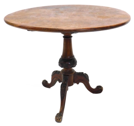 A low Victorian mahogany occasional table, the circular top on a turned column and carved tripod base, 54cm high, 57cm diameter.