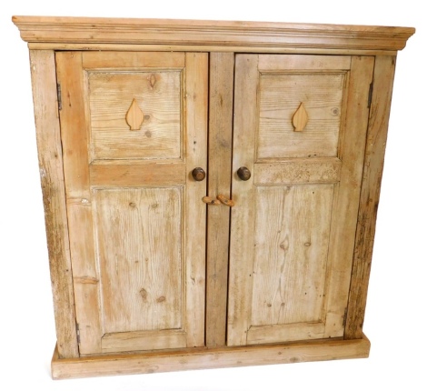 A pine cupboard, with a moulded cornice with two panelled doors, on plinth base, adapted from old timber, 114cm high, 113cm wide, 54.5cm deep.