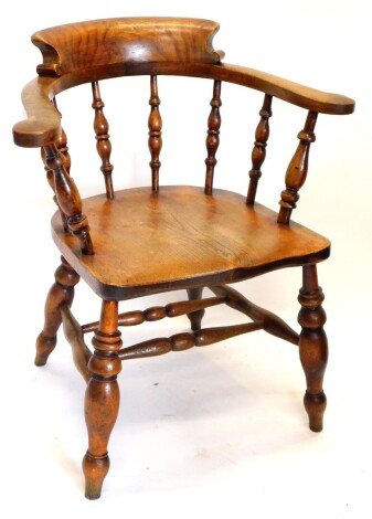 A 19thC ash and elm smoker's bow chair, with spindle turned supports, turned legs with H stretcher. Note: VAT is payable on the hammer price of this lot at 20%.