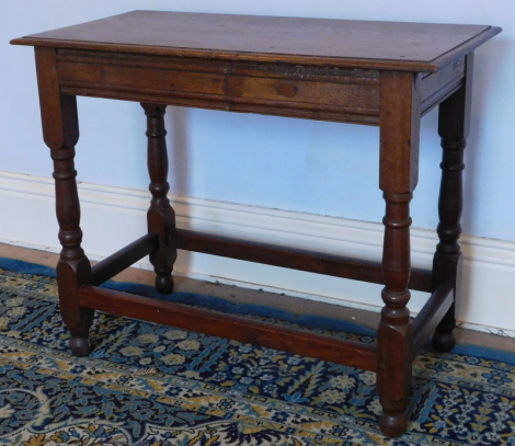 An oak table, in 17thC style with moulded top, shaped frieze, turned legs and plain stretchers, 84cm x 43cm.