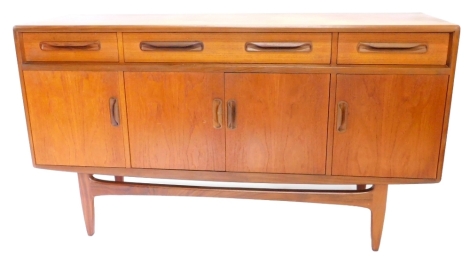 A G-Plan teak sideboard, with three frieze drawers above four doors, on tapering legs, 75cm high, 151cm wide, 45cm deep.
