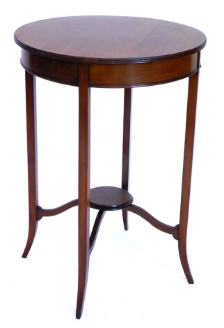 An Edwardian mahogany two tier occasional table, the circular top with a reeded edge on splayed legs, 72cm high, 50cm diameter.