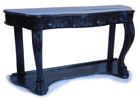 An early 19thC ebonised oak console table, the serpentine shaped top with a moulded edge, above a carved frieze with a single drawer, cabriole supports with paw feet, on a shallow concave platform, 77cm high, 150cm wide, 53cm deep.