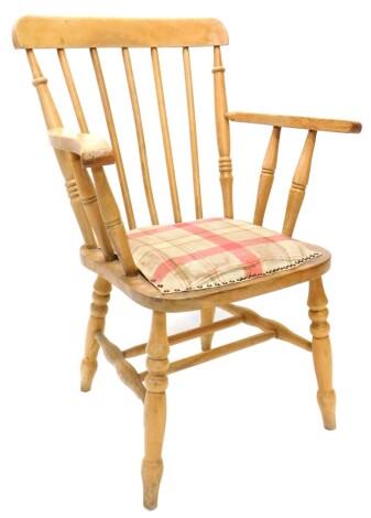 A beech Windsor type open chair, with spindle turned supports, an upholstered padded seat, on turned legs with H stretcher.