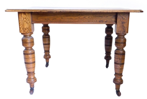 A Victorian oak extending dining table, the rectangular top with canted corners and a moulded edge, on turned tapering legs with castors, lacking leaves, 72cm high, the top 101cm x 104cm. Note: VAT is payable on the hammer price of this lot at 20%.