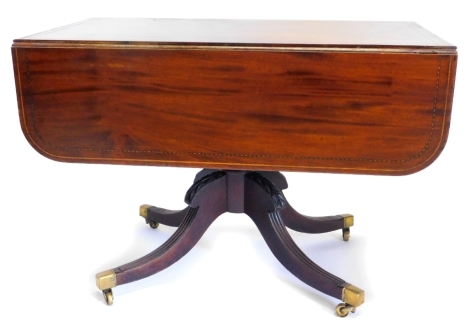 An early 19thC mahogany boxwood and chequer banded Pembroke table, the rectangular top with rounded cornice, above a single drawer to one end, with false drawer on a turned column and four reeded splayed legs, with castors, 103cm wide.