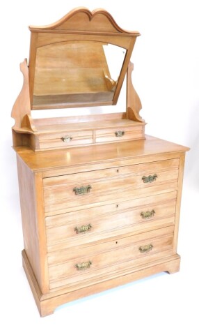 A Victorian pale walnut dressing table, the raised back with an arched bevel mirror plate above two trinket drawers, an arrangement of three drawers each with drop handles and bracket feet, 92cm wide.