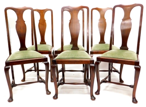 A set of six early 20thC mahogany dining chairs in Queen Anne style, each with a solid splat, a drop in seat on cabriole legs with pad feet, label for T G Woof Limited, manufacturing cabinet makers, Sheffield.