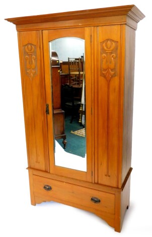 A Victorian satin walnut wardrobe, with a moulded cornice above a single door with bevel plate, and a drawer, on bracket feet, 195cm high, 115cm wide.