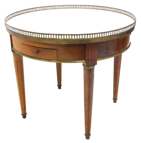 A French mahogany low table, with a brass pierced gallery and a white marble top, above two drawers, and two slides on fluted turned tapering legs, 52cm high, 61.5cm diameter.