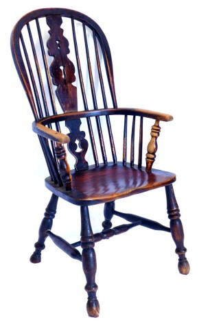 A mid 19thC ash and elm Windsor chair, with a pierced splat, turned supports and solid seat, on turned legs with H stretcher.