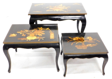 A nest of three oriental lacquer tables, each decorated in gilt with urns of flowers, etc., on a black ground, with shaped tapering cabriole legs, the largest 46cm high, 65cm wide.