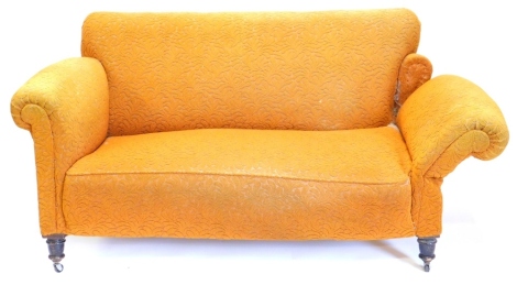 A late 19th/early 20thC two seat drop arm sofa, upholstered in yellow fabric with turned legs and castors, 151cm wide.