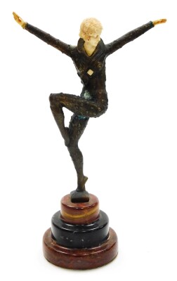 After Demetre Chiparus (1886-1947). Dancing female, an Art Deco bronze figure based on The Dancer of Kapurthala, with ivorine hands, head and body insert, signed D H Chiparus, and raised on a three layer circular onyx plinth, 31cm high.