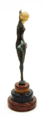 After Demetre Chiparus (1886-1947). Dancing female, an Art Deco bronze figure based on The Dancer of Kapurthala, with ivorine hands, head and body insert, signed D H Chiparus, and raised on a three layer circular onyx plinth, 31cm high. - 2