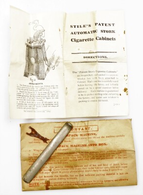 The 'Stork' patent cigarette cabinet, being a hammered and anodised example with oval Ruskin enamel centres, complete with most of the original wooden packaging box, the instruction booklet for 'Stile's Patent', and bar lever in envelope, 29cm high. - 7