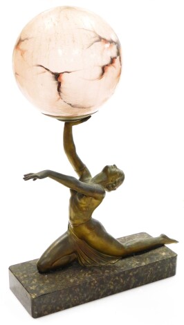 An Art Deco table lamp, in the form of a bronzed patination spelter figure of a kneeling female, on a rounded rectangular marble base, and having a frosted colour veined globe shade, 49cm high, 30cm wide.