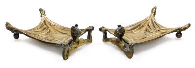 A pair of early 20thC cast bronze desk stands, being card trays formed with an outstretched figure of the Devil in bed, a humoured invitation for those to leave their cards should they wish to do business with the Devil? One cast with the maker's mark of - 2