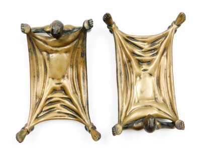 A pair of early 20thC cast bronze desk stands, being card trays formed with an outstretched figure of the Devil in bed, a humoured invitation for those to leave their cards should they wish to do business with the Devil? One cast with the maker's mark of - 3