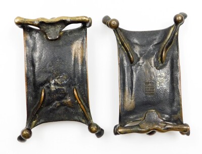 A pair of early 20thC cast bronze desk stands, being card trays formed with an outstretched figure of the Devil in bed, a humoured invitation for those to leave their cards should they wish to do business with the Devil? One cast with the maker's mark of - 4