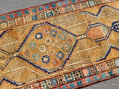 An early 20thC Sarab design carpet runner, with two stylised borders, enclosing a central floral medallion field, with trees, 460cm x 86cm. - 2