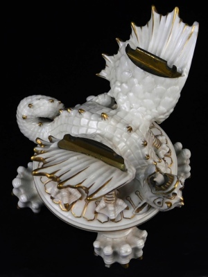 A second period Belleek Dragon tea kettle, cover and stand, second period black mark, 1891-1926, decorated with the highlights, picked out in gold, 35cm high. (3) For an example of a similar dragon tea kettle on stand see Irish Porcelain page 107. - 6