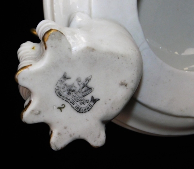 A second period Belleek Dragon tea kettle, cover and stand, second period black mark, 1891-1926, decorated with the highlights, picked out in gold, 35cm high. (3) For an example of a similar dragon tea kettle on stand see Irish Porcelain page 107. - 7