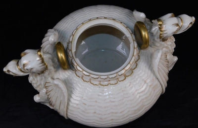 A second period Belleek Dragon tea kettle, cover and stand, second period black mark, 1891-1926, decorated with the highlights, picked out in gold, 35cm high. (3) For an example of a similar dragon tea kettle on stand see Irish Porcelain page 107. - 12