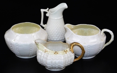 A group of first green mark Belleek wares, comprising of Tridacna creamer with yellow band and gilt shamrocks, new shell sugar basin with highlighted band and creamer en-suite and a helmet shaped creamer with a J shaped handle and scale moulding. (4)