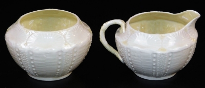 A group of first green mark Belleek wares, comprising of Tridacna creamer with yellow band and gilt shamrocks, new shell sugar basin with highlighted band and creamer en-suite and a helmet shaped creamer with a J shaped handle and scale moulding. (4) - 2