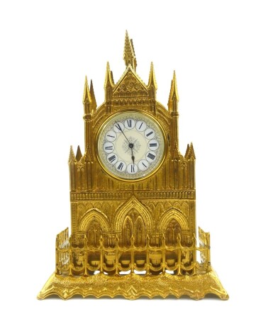 A late 19thC brass cased cathedral mantel clock, circular cream painted dial bearing Roman numerals in white reserves, clockwork movement, the case of Gothic form, no key, 36cm high.