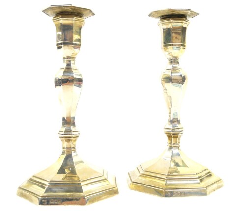 A pair of Edward VII loaded silver candlesticks, of octagonal baluster form, Goldsmiths & Silversmiths Company, London 1899., 46.58oz all in, 21cm high.