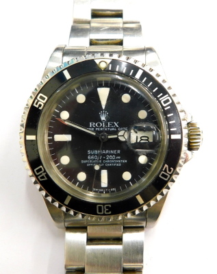 A 1979 Rolex Submariner model 1680, serial 61582**, having stainless steel case and Oyster bracelet, T<25 dial with applied lume markers. With original inner and outer boxes, bill of sale, hang tags, anchor, case stickers, warranty cards, and service doc