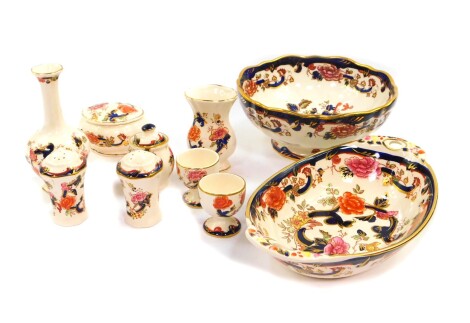 A group of Masons Ironstone decorated in the Mandalay pattern, comprising a twin handled oval dish, fluted circular pedestal fruit bowl, two vases, trinket box and cover, a pair of egg cups and a three piece cruet. (10)